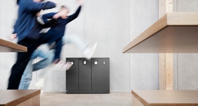 Waste bins at school with happy students
